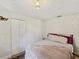 Cozy bedroom with geometric rug, overhead lighting, closet, and neutral tones at 106 W Louisiana Ave, Tampa, FL 33603