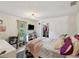 Bedroom with natural light, closet, television, decorative lighting, and unique decor at 106 W Louisiana Ave, Tampa, FL 33603