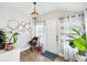 Inviting entryway with decorative lighting fixture, wood-look floors and light neutral paint at 106 W Louisiana Ave, Tampa, FL 33603