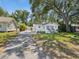 Exterior shot of the home showing the gated driveway and landscaping at 106 W Louisiana Ave, Tampa, FL 33603