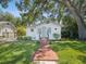 Charming home featuring a well-manicured lawn, brick walkway, and tidy landscaping at 106 W Louisiana Ave, Tampa, FL 33603