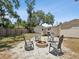 Outdoor fire pit surrounded by chairs in a backyard setting at 106 W Louisiana Ave, Tampa, FL 33603