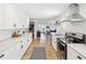 Bright kitchen features stainless steel appliances, white subway tile backsplash, wood floors, and ample countertop space at 106 W Louisiana Ave, Tampa, FL 33603