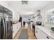 Bright kitchen features stainless steel appliances, white cabinetry, subway tile backsplash, and long countertops at 106 W Louisiana Ave, Tampa, FL 33603