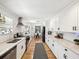Updated kitchen with granite counters, stainless appliances, and bright white cabinets at 106 W Louisiana Ave, Tampa, FL 33603