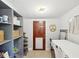 Laundry room with door to outside, shelving, and front loading washer and dryer at 106 W Louisiana Ave, Tampa, FL 33603