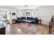 Well-lit living room with beautiful hardwood floors, a blue sofa, and a neutral color scheme at 106 W Louisiana Ave, Tampa, FL 33603