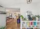 Open-concept living room with hardwood floors, white walls, and decorative shelving at 106 W Louisiana Ave, Tampa, FL 33603