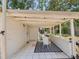 Covered patio with seating area, tiled floor, and backyard views at 106 W Louisiana Ave, Tampa, FL 33603