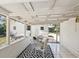 Covered patio with outdoor seating and a black and white rug at 106 W Louisiana Ave, Tampa, FL 33603
