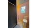Efficient bathroom with a tiled shower, toilet, and natural light from the adjacent window at 10953 Winter Crest Dr, Riverview, FL 33569