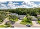 Aerial view of the house showcasing its location within a neighborhood surrounded by lush greenery and mature trees at 13038 Royal George Ave, Odessa, FL 33556