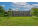 Large backyard featuring a screened patio with a hot tub at 13038 Royal George Ave, Odessa, FL 33556