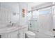 Bright bathroom with a marble vanity top, white cabinets, and a glass-enclosed shower at 13038 Royal George Ave, Odessa, FL 33556