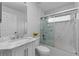 Modern bathroom with a shower over bath and white marble tile surround at 13038 Royal George Ave, Odessa, FL 33556