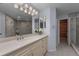 Bathroom with large vanity, soft lighting, and tile flooring plus glass enclosed shower at 13038 Royal George Ave, Odessa, FL 33556