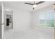 Bedroom with white marble-look floors and plantation shutters on the window at 13038 Royal George Ave, Odessa, FL 33556