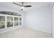 Bedroom with white marble-look floors and plantation shutters on the window at 13038 Royal George Ave, Odessa, FL 33556