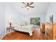 Bright bedroom with sliding door to patio, features wood floors and a ceiling fan at 13038 Royal George Ave, Odessa, FL 33556