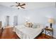 Bedroom features wood floors, ceiling fan, and a king size bed with a decorative comforter at 13038 Royal George Ave, Odessa, FL 33556