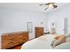 Bedroom featuring wood floors, ceiling fan and ensuite bathroom access at 13038 Royal George Ave, Odessa, FL 33556
