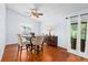 Cozy dining area featuring hardwood floors, stylish furnishings, and sliding glass door access at 13038 Royal George Ave, Odessa, FL 33556