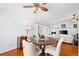 Cozy dining area features wood floors, a round table, and flows into a living room with a fireplace at 13038 Royal George Ave, Odessa, FL 33556