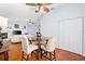 Open dining area with hardwood floors, a ceiling fan, and convenient access to the living area at 13038 Royal George Ave, Odessa, FL 33556