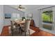 Dining room with natural light, wood floors, area rug, and slider to the backyard at 13038 Royal George Ave, Odessa, FL 33556