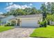 Charming single-story home with a well-manicured lawn and a brick paved driveway leading to a two-car garage at 13038 Royal George Ave, Odessa, FL 33556