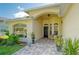 Inviting front entrance featuring a seating area and lovely landscaping at 13038 Royal George Ave, Odessa, FL 33556