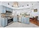 Open concept kitchen with modern appliances, granite counters, and adjacent living area at 13038 Royal George Ave, Odessa, FL 33556