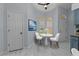 Eat-in kitchen features a breakfast nook with white table and chairs, complemented by natural light at 13038 Royal George Ave, Odessa, FL 33556