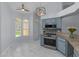 Kitchen with stainless steel appliances, granite countertops, backsplash, and eat-in nook with large windows at 13038 Royal George Ave, Odessa, FL 33556