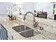 Close up view of kitchen granite countertop with stainless steel sink and decorative faucet at 13038 Royal George Ave, Odessa, FL 33556