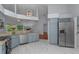 Updated kitchen showcasing stainless steel appliances, granite countertops, and contemporary lighting at 13038 Royal George Ave, Odessa, FL 33556