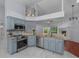 Stylish kitchen with updated appliances, modern countertops, and contemporary light fixtures at 13038 Royal George Ave, Odessa, FL 33556