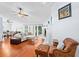 Bright living room featuring hardwood floors, a fireplace, and comfortable seating arrangement at 13038 Royal George Ave, Odessa, FL 33556