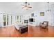 Open living area with hardwood floors, a cozy fireplace, and plenty of natural light at 13038 Royal George Ave, Odessa, FL 33556