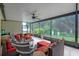 Large screened patio with seating and a view of the garden at 13038 Royal George Ave, Odessa, FL 33556
