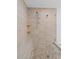 Step-in shower with pebble floor, dual shower heads and a built-in tiled niche at 13038 Royal George Ave, Odessa, FL 33556