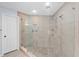 Shower with pebble floor, seating, dual shower heads and a built-in tiled niche at 13038 Royal George Ave, Odessa, FL 33556