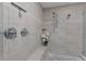 Spacious glass shower showcasing tile walls, pebble floor, and modern fixtures at 13038 Royal George Ave, Odessa, FL 33556