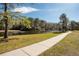 Picturesque walking path beside a tranquil pond, perfect for leisurely strolls and enjoying nature at 13038 Royal George Ave, Odessa, FL 33556