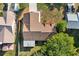 Aerial view of a home displaying the roof, driveway, and landscaping with mature trees in a residential neighborhood at 1308 Peachfield Dr, Valrico, FL 33596
