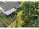 Aerial view of a home's backyard featuring a screened-in porch and lush green lawn with mature trees providing shade at 1308 Peachfield Dr, Valrico, FL 33596