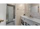 Bathroom features a white vanity with modern fixtures and a shower with decorative curtain at 1308 Peachfield Dr, Valrico, FL 33596