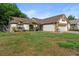 Charming home with a well-manicured lawn, mature trees, and an attached garage, offering great curb appeal at 1308 Peachfield Dr, Valrico, FL 33596