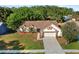 Charming home with a well-manicured lawn, mature trees, and an attached garage, offering great curb appeal at 1308 Peachfield Dr, Valrico, FL 33596
