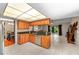 Kitchen featuring wooden cabinets, stainless steel appliances, and a view of the living area at 1308 Peachfield Dr, Valrico, FL 33596